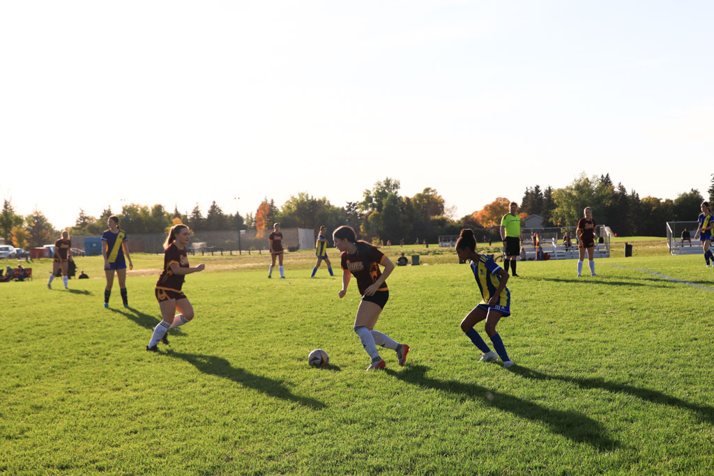 Girls Soccer Leboldus and O'neill players battle for the ball on the pitch